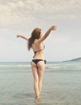 woman-in-black-bikini-standing-on-shore-825904-1024x653